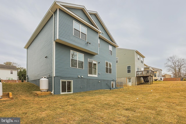 rear view of house with a residential view, a yard, and a deck