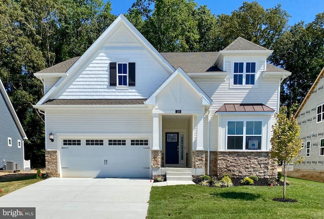 view of front facade featuring cooling unit, a garage, and a front yard