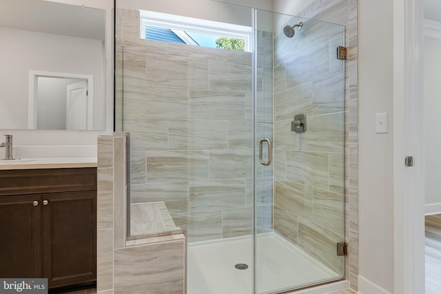 bathroom featuring vanity and an enclosed shower