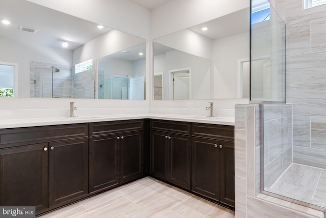 bathroom featuring vanity, a healthy amount of sunlight, and an enclosed shower