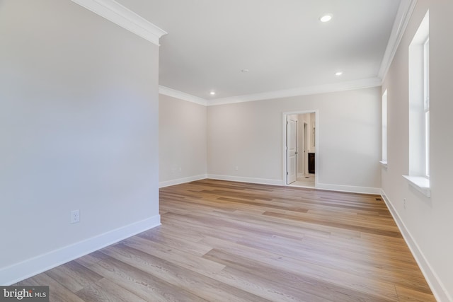 unfurnished room with crown molding and light hardwood / wood-style floors