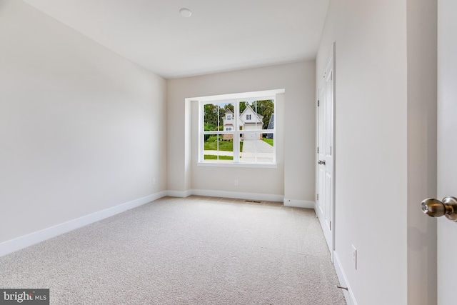 empty room featuring light colored carpet