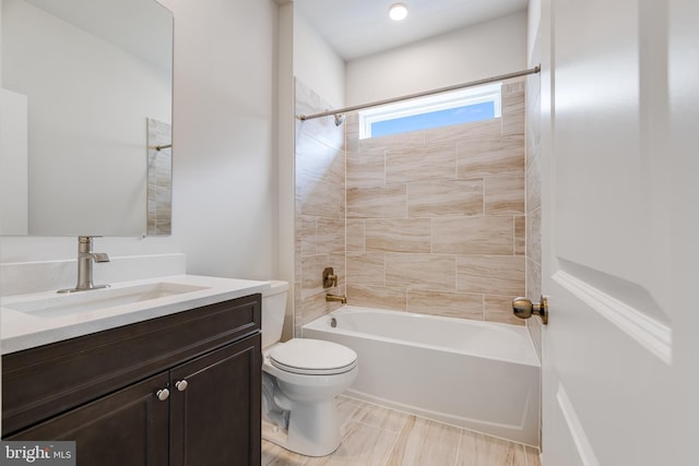 full bathroom featuring toilet, vanity, and tiled shower / bath