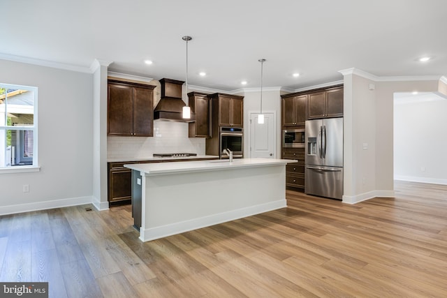 kitchen with custom range hood, dark brown cabinets, stainless steel appliances, light hardwood / wood-style floors, and hanging light fixtures