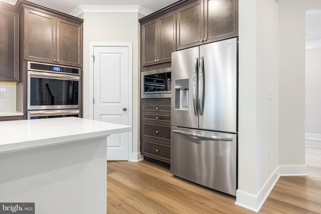 kitchen featuring dark brown cabinets, light wood-type flooring, and stainless steel appliances