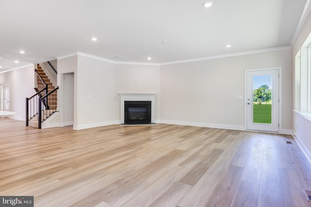 unfurnished living room with ornamental molding and light hardwood / wood-style flooring