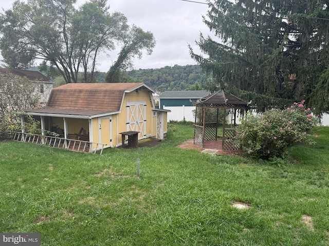 view of yard featuring a gazebo and a shed