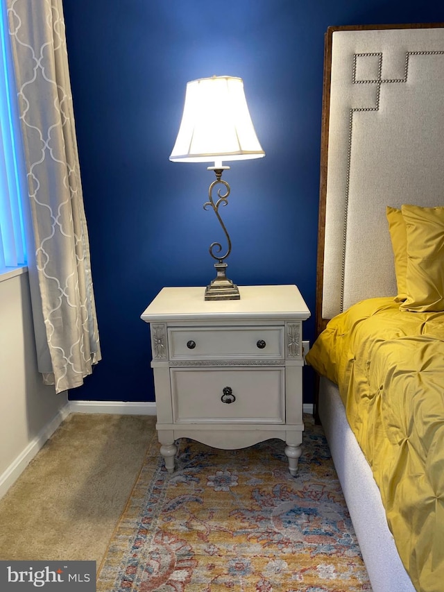 bedroom featuring dark colored carpet