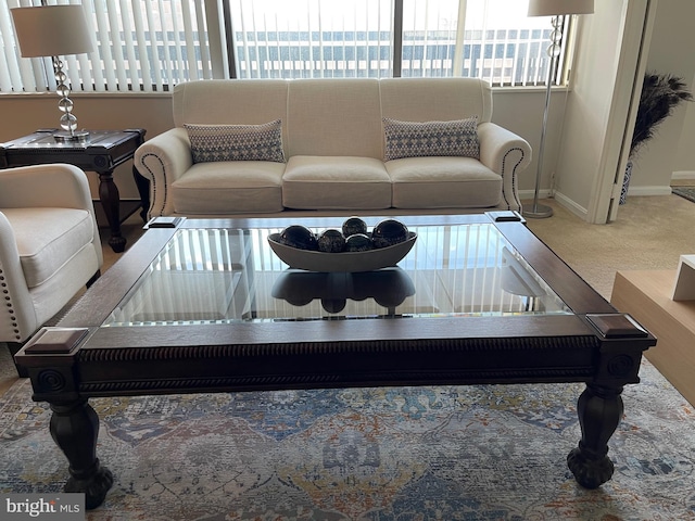 living room with a water view and carpet floors