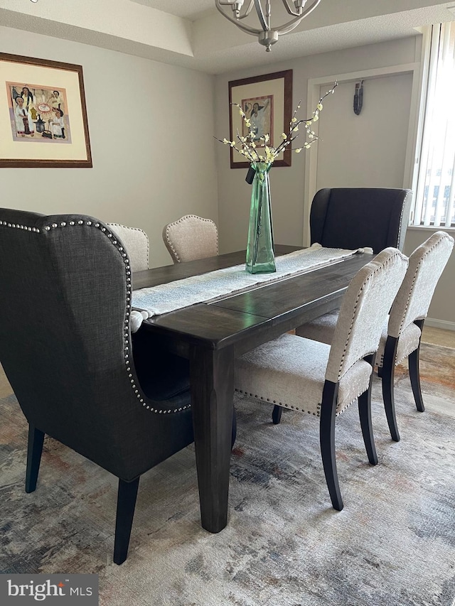 dining area featuring a notable chandelier