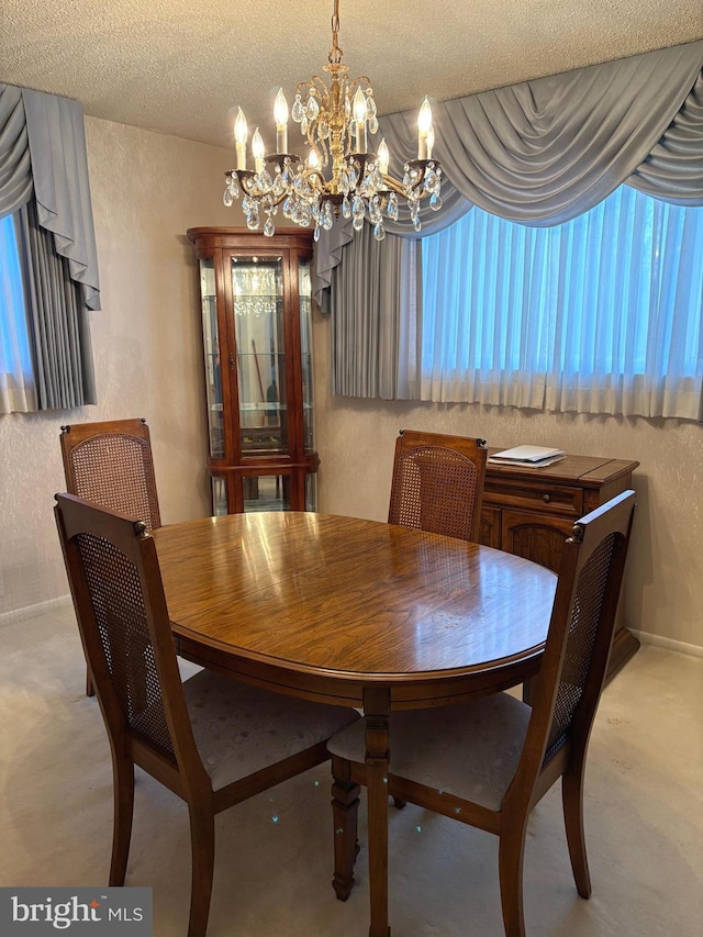 dining room with a textured ceiling and a chandelier