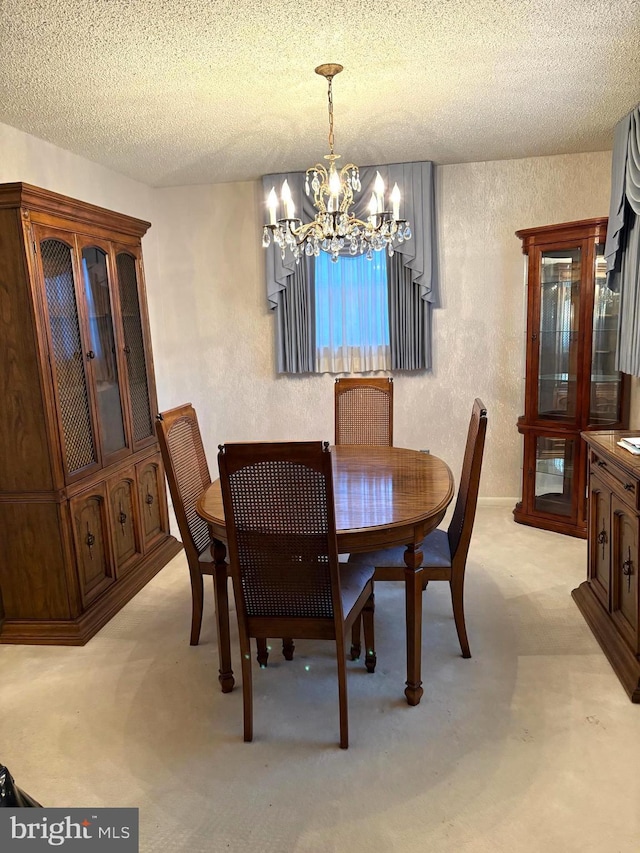 dining space featuring a textured ceiling and a notable chandelier