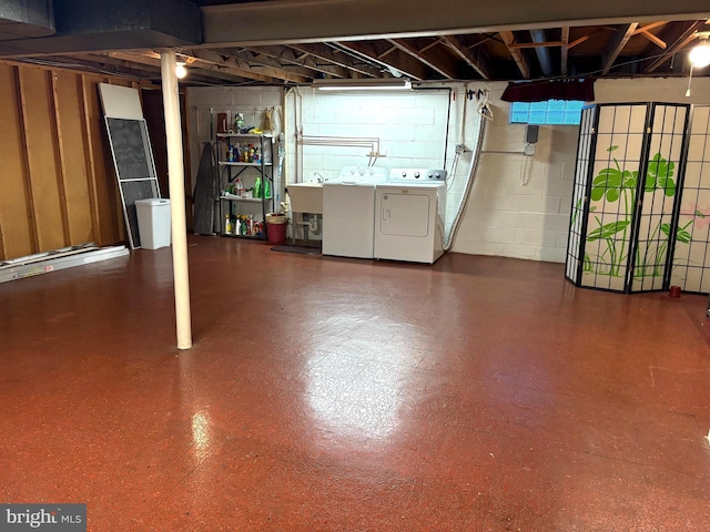 basement with sink and washer and dryer