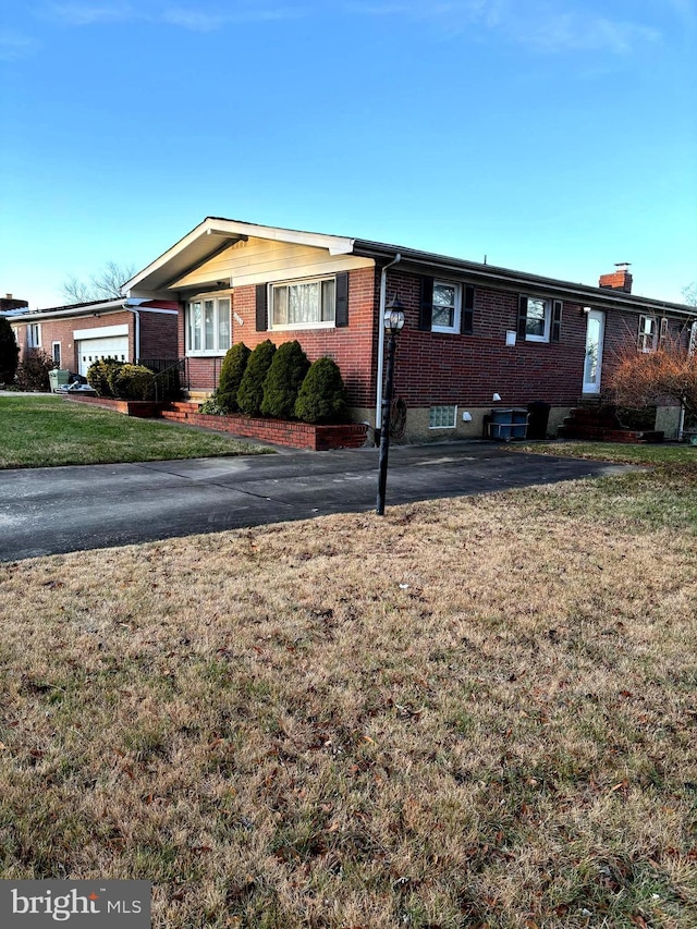 view of front of property with a front yard and a garage