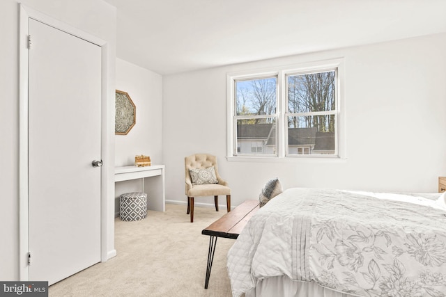 carpeted bedroom featuring baseboards