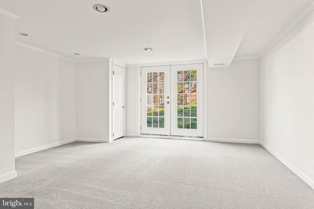carpeted spare room with crown molding, recessed lighting, baseboards, and french doors