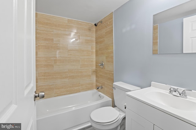 full bathroom with vanity, toilet, and tiled shower / bath