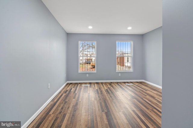 unfurnished room featuring dark wood-type flooring