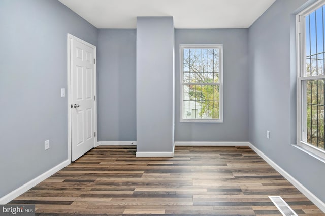 unfurnished room featuring dark wood-type flooring