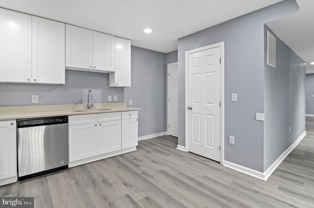 kitchen with dishwasher, light wood-type flooring, white cabinets, and sink