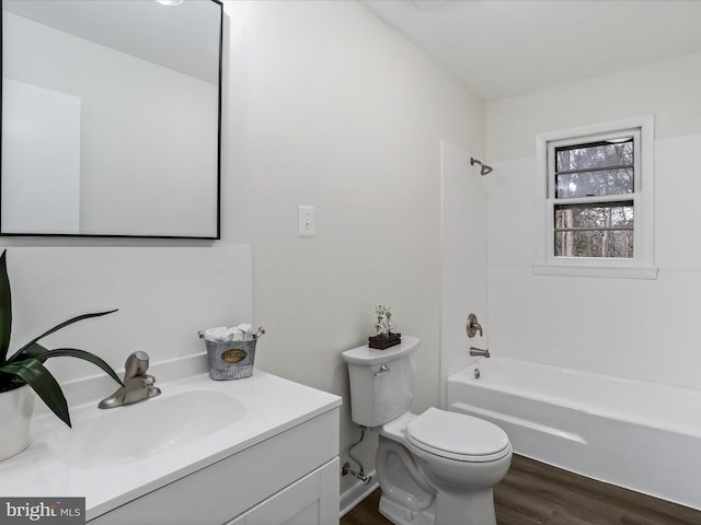 full bathroom with hardwood / wood-style floors, vanity, toilet, and tub / shower combination