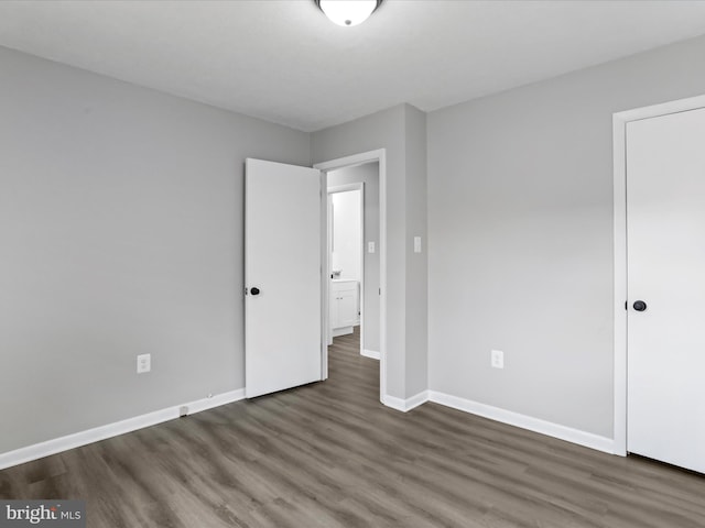 unfurnished bedroom featuring dark hardwood / wood-style flooring