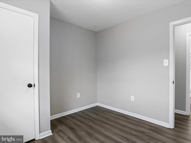 spare room featuring dark hardwood / wood-style flooring