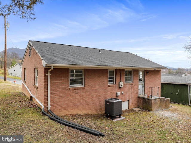 rear view of house with central AC