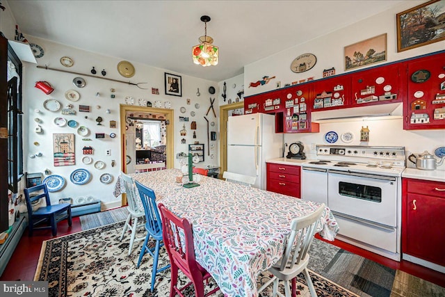 kitchen with dark wood-type flooring, white appliances, and a baseboard heating unit