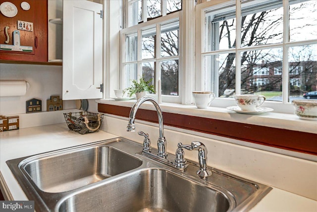 room details with white cabinetry and sink