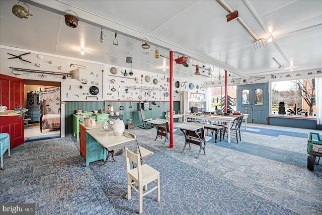 carpeted dining room with a workshop area