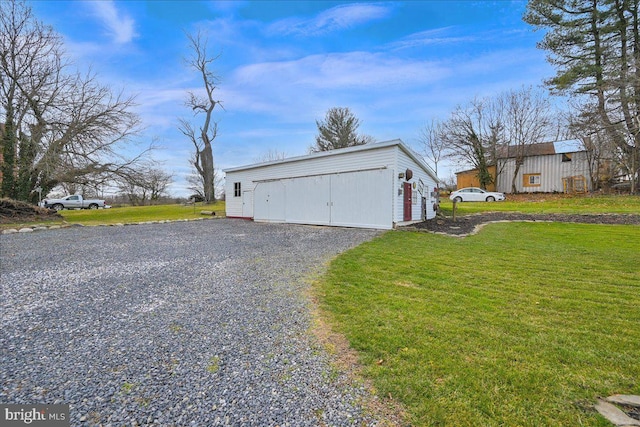 garage featuring a lawn