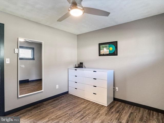 unfurnished bedroom with dark hardwood / wood-style flooring and ceiling fan