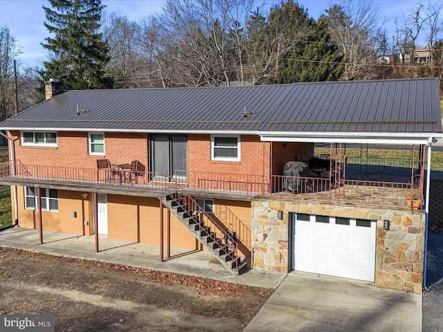 rear view of house featuring a garage