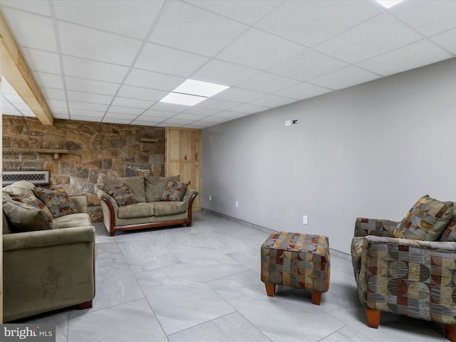 living room with a paneled ceiling