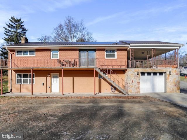 view of front of property with a balcony and a garage