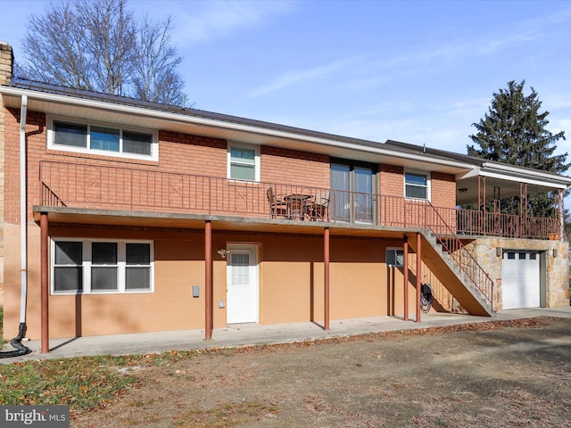 back of property featuring a garage