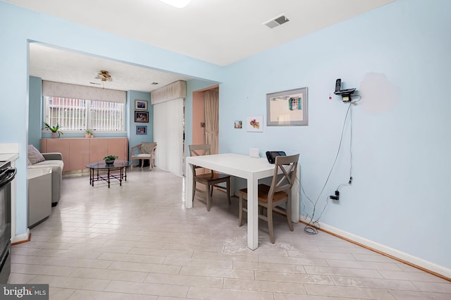 dining area featuring light tile patterned flooring