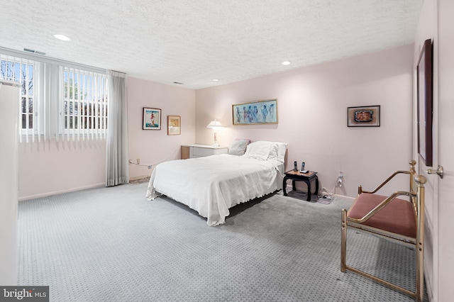 carpeted bedroom with a textured ceiling