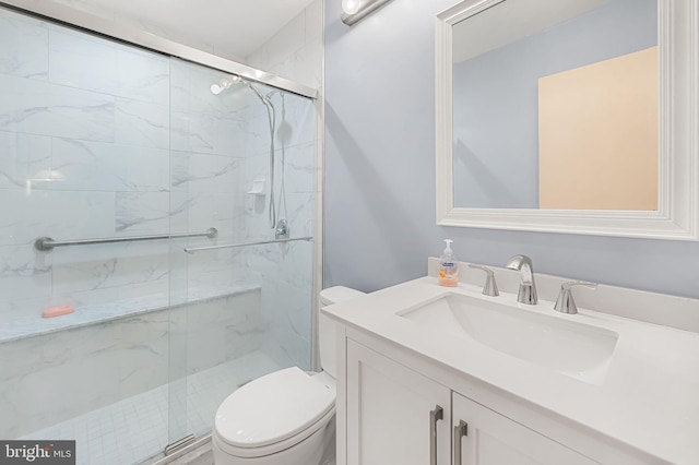 bathroom with vanity, an enclosed shower, and toilet