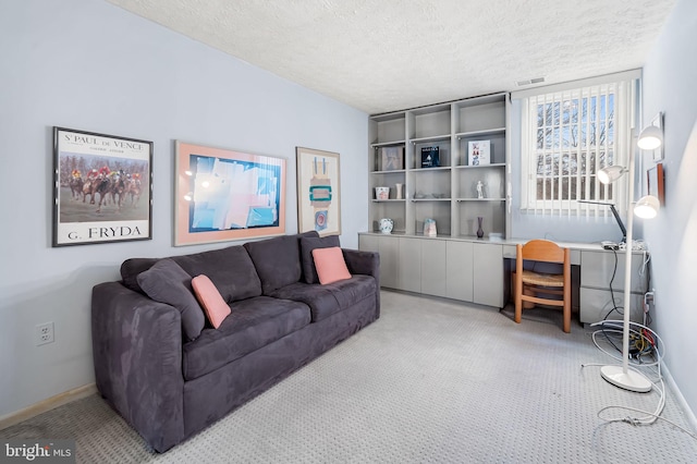 living room with a textured ceiling and light colored carpet