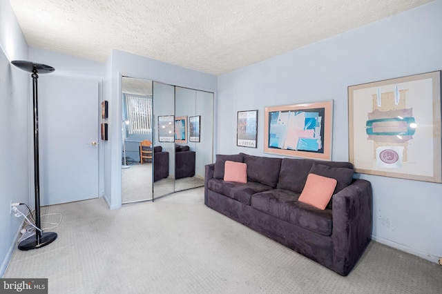 living room with a textured ceiling and light carpet