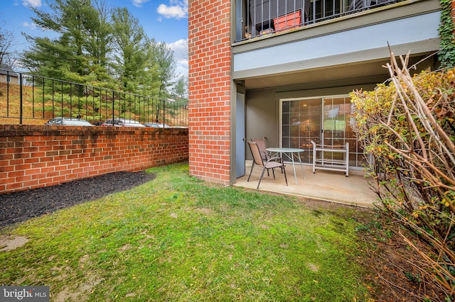 view of yard with a balcony and a patio