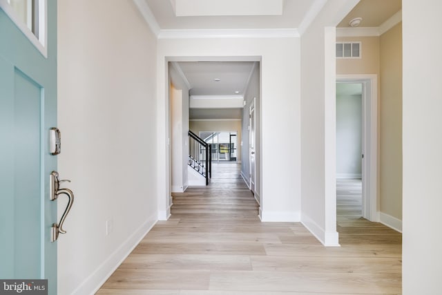 corridor featuring crown molding and light hardwood / wood-style floors