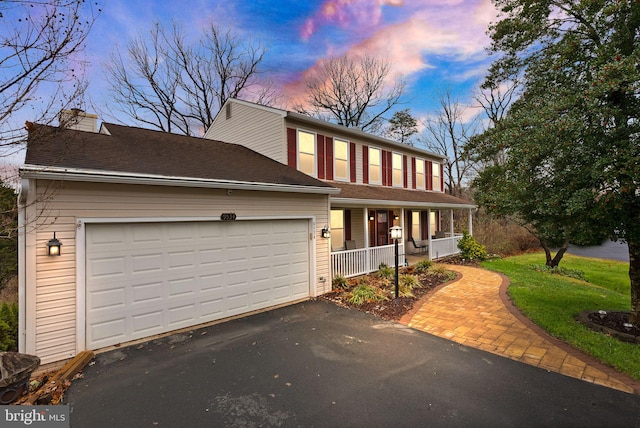 view of front of home with a porch and a garage