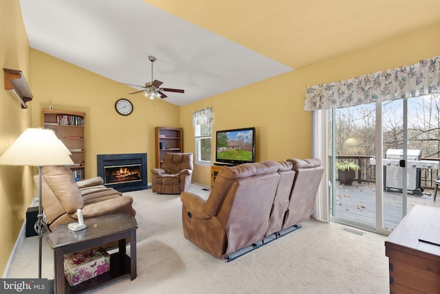 living room with light carpet, ceiling fan, and lofted ceiling