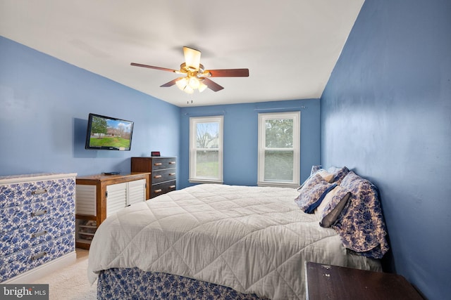 bedroom featuring light carpet and ceiling fan