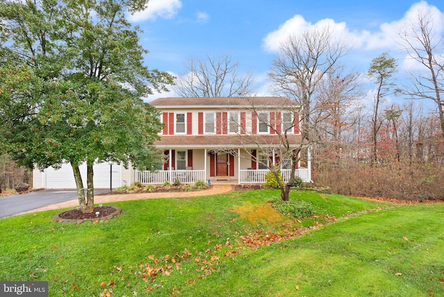 colonial inspired home featuring a front lawn and covered porch