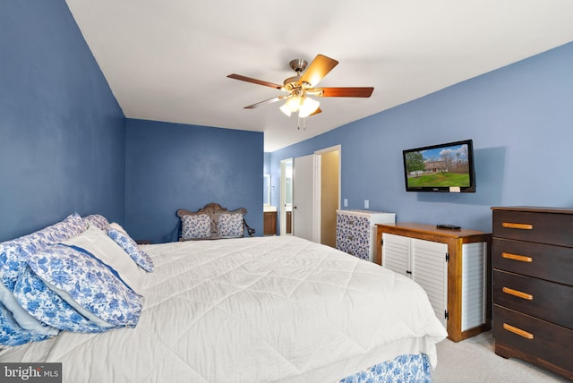 carpeted bedroom featuring ensuite bathroom and ceiling fan