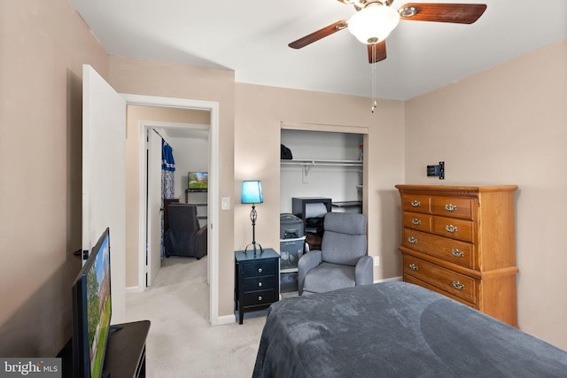 carpeted bedroom with ceiling fan and a closet